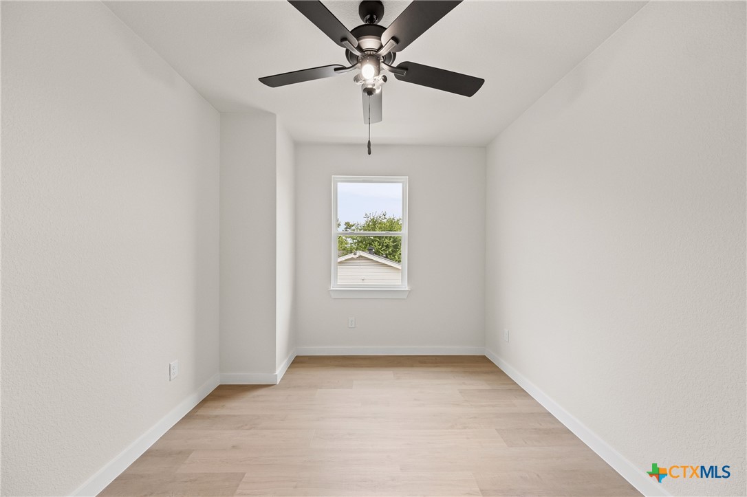 1204 Martin Luther King Jr Lane, Unit A Temple, TX 76504 - Photo 13 of 21 an empty room with windows and fan