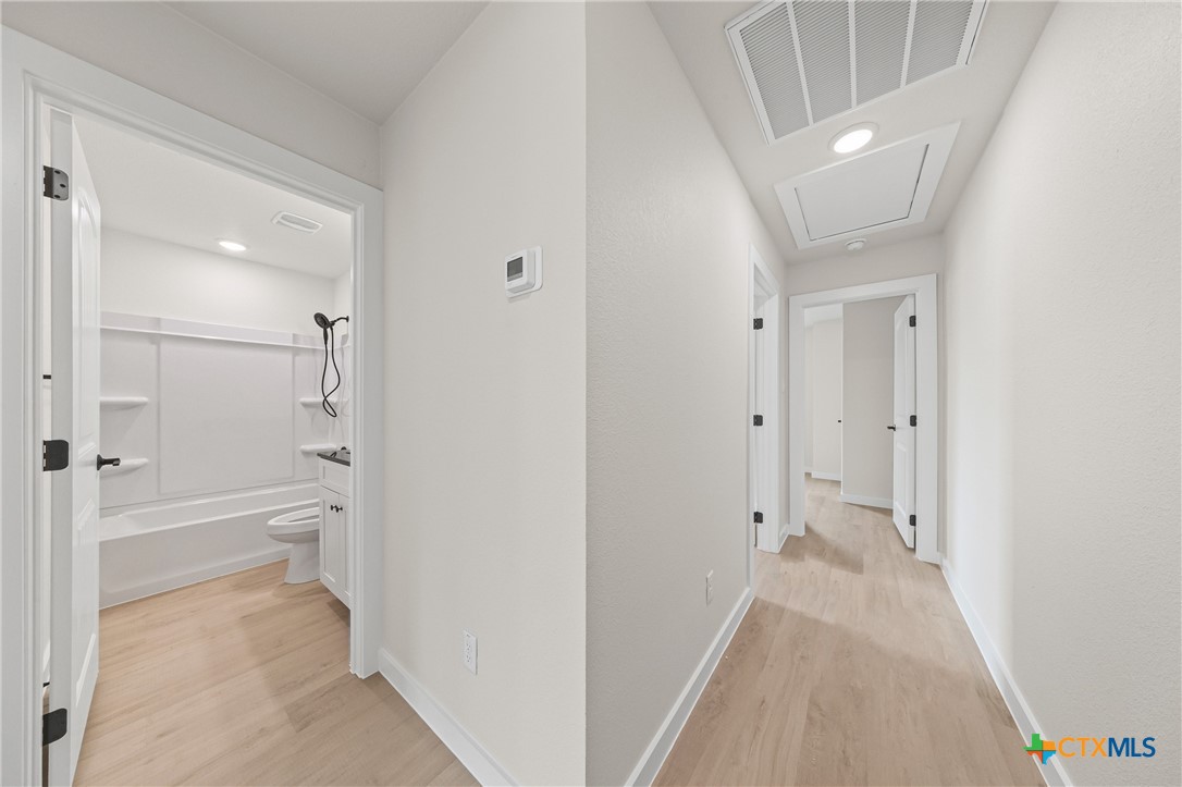 1204 Martin Luther King Jr Lane, Unit A Temple, TX 76504 - Photo 15 of 21 a view of a bathroom with a bathtub and a toilet