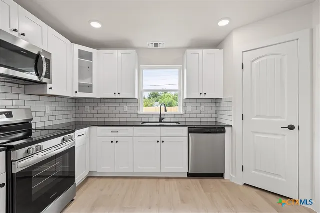 a kitchen with a sink and cabinets