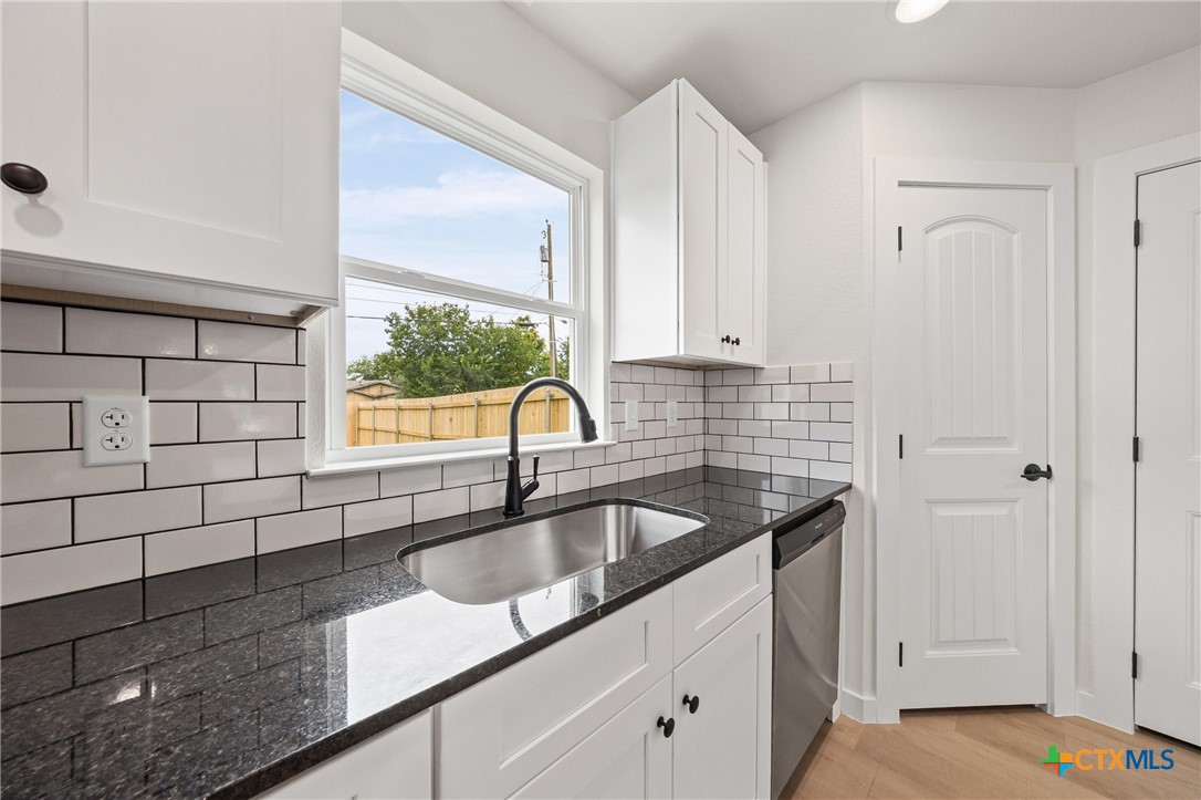 1204 Martin Luther King Jr Lane, Unit A Temple, TX 76504 - Photo 7 of 21 a kitchen with a sink and cabinets