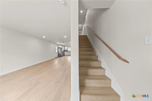 an empty room with window and ceiling fan