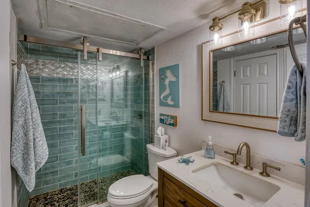 a bathroom with a sink toilet and shower