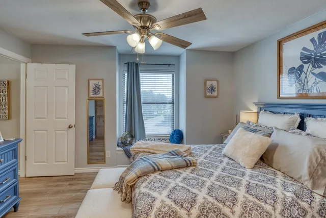 a bedroom with a large bed and a window