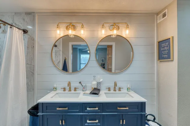a bathroom with a double vanity sink and a mirror