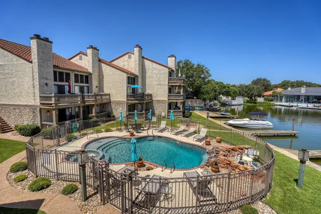 a view of a house with swimming pool and sitting area