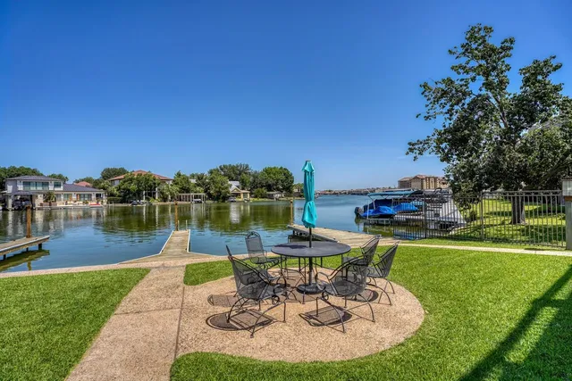 a view of a lake with a table and chairs