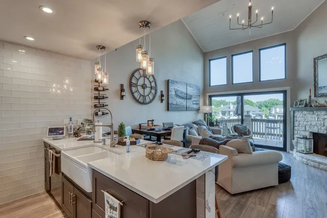 a bathroom with a sink and a large mirror with wooden floor