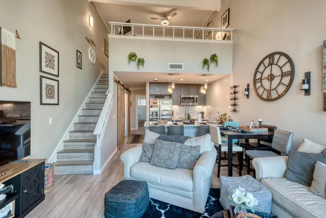 a living room with furniture and wooden floor