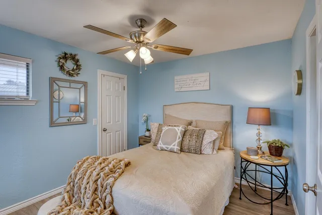 a bedroom with a bed and a chandelier