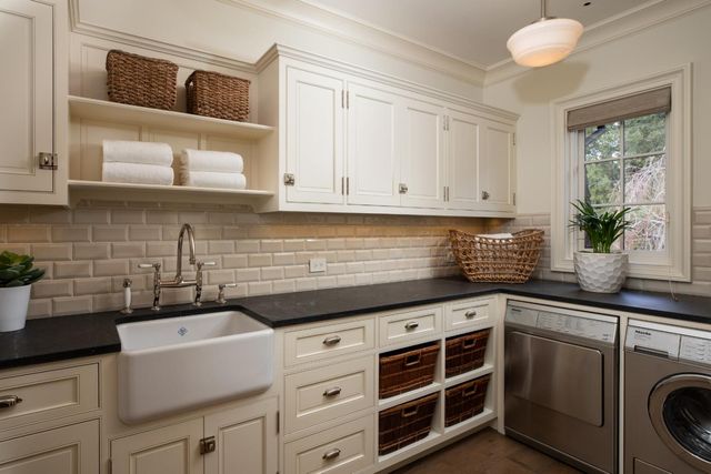 a kitchen with granite countertop a sink a stove and cabinets