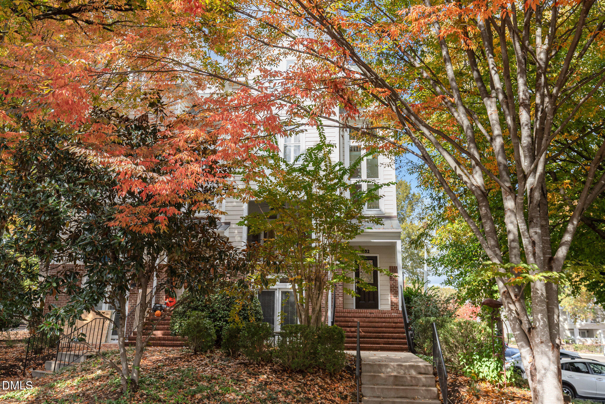 a front view of a house with a tree