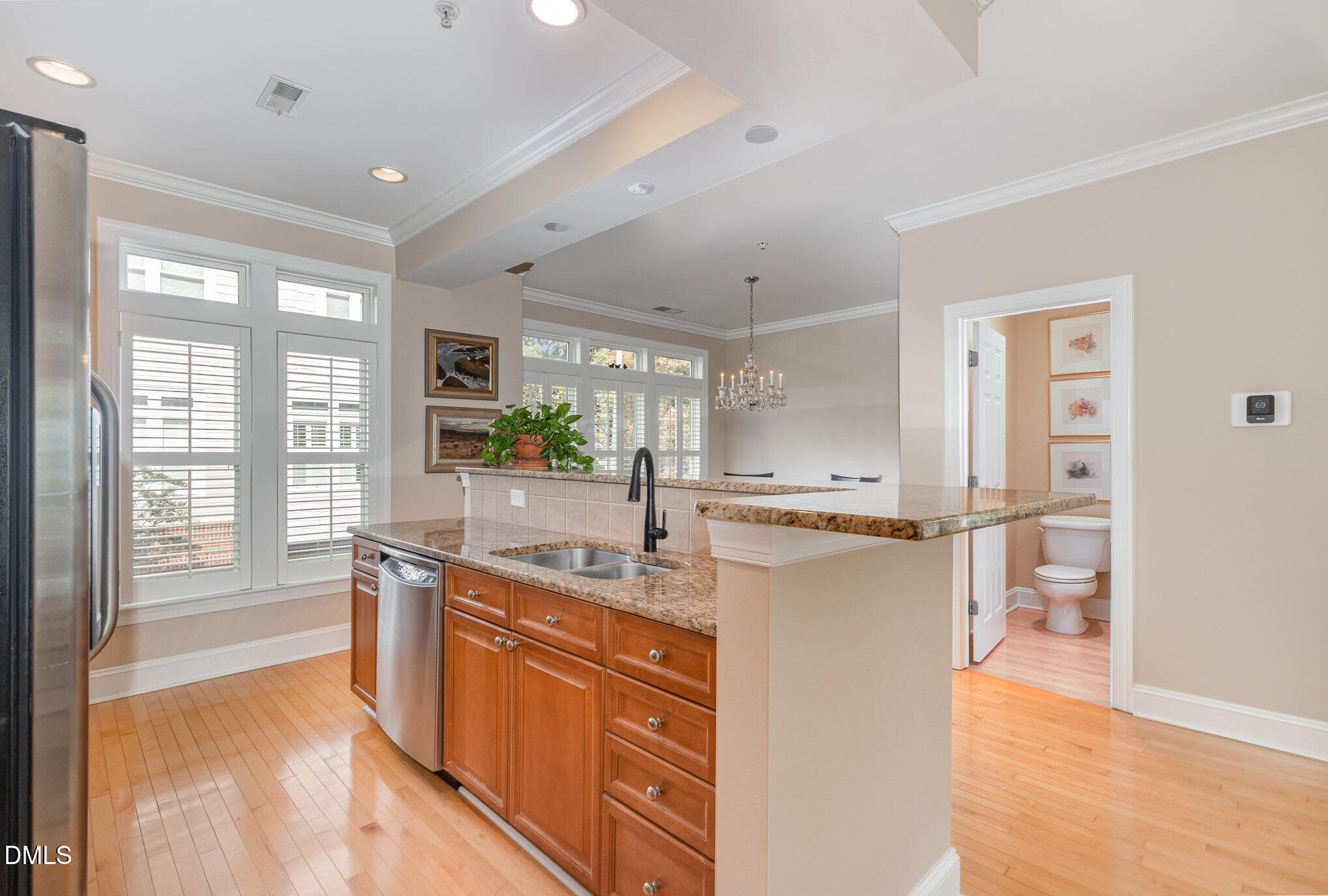 1120 Parkridge Lane, Unit 102 Raleigh, NC 27605 - Photo 18 of 50 a kitchen with stainless steel appliances granite countertop a refrigerator a sink and a stove with wooden floor