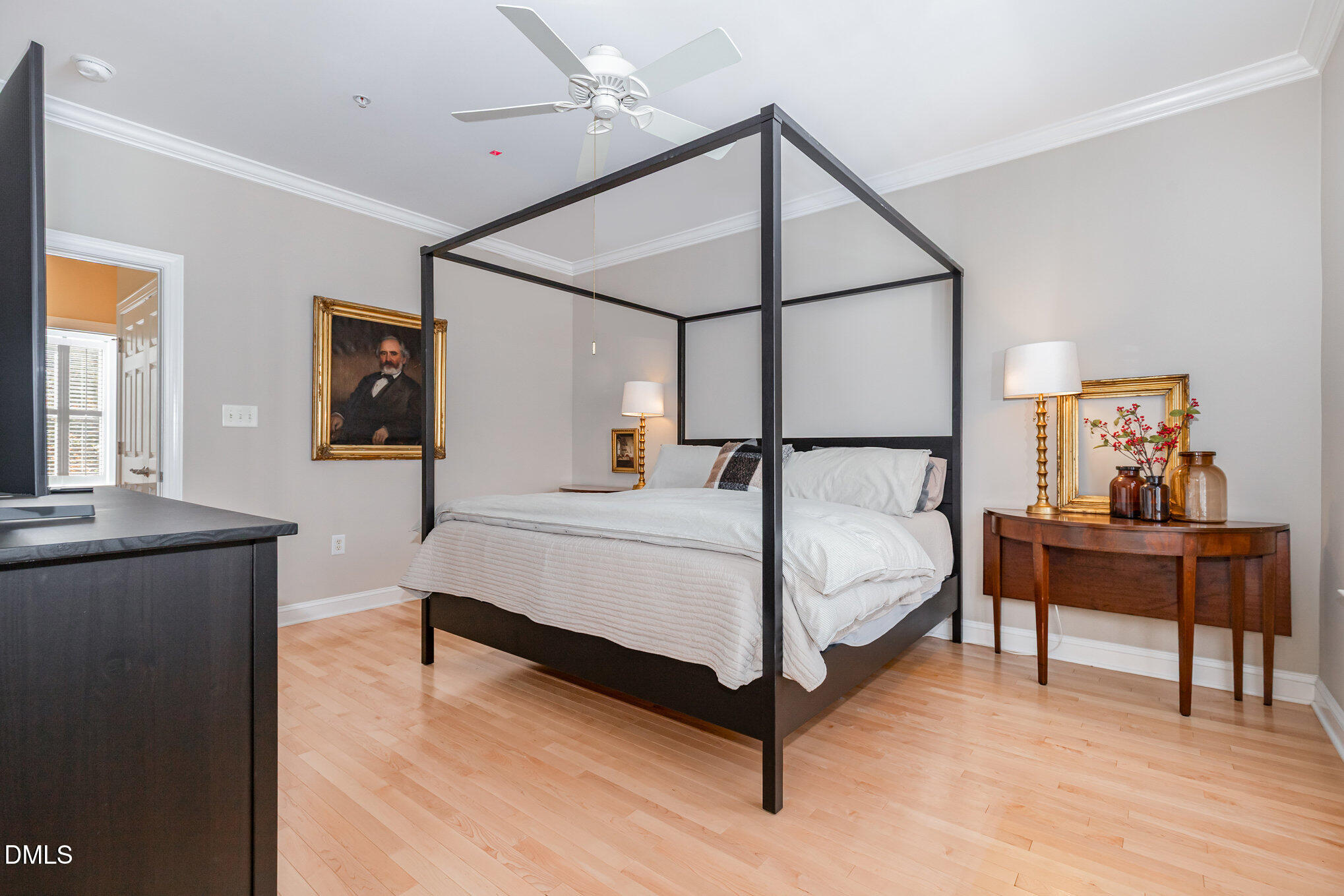 1120 Parkridge Lane, Unit 102 Raleigh, NC 27605 - Photo 27 of 50 a bedroom with a bed and wooden floor