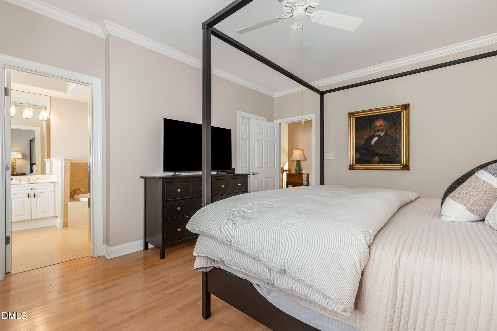 1120 Parkridge Lane, Unit 102 Raleigh, NC 27605 - Photo 28 of 50 a bedroom with a bed and a flat tv screen on dresser