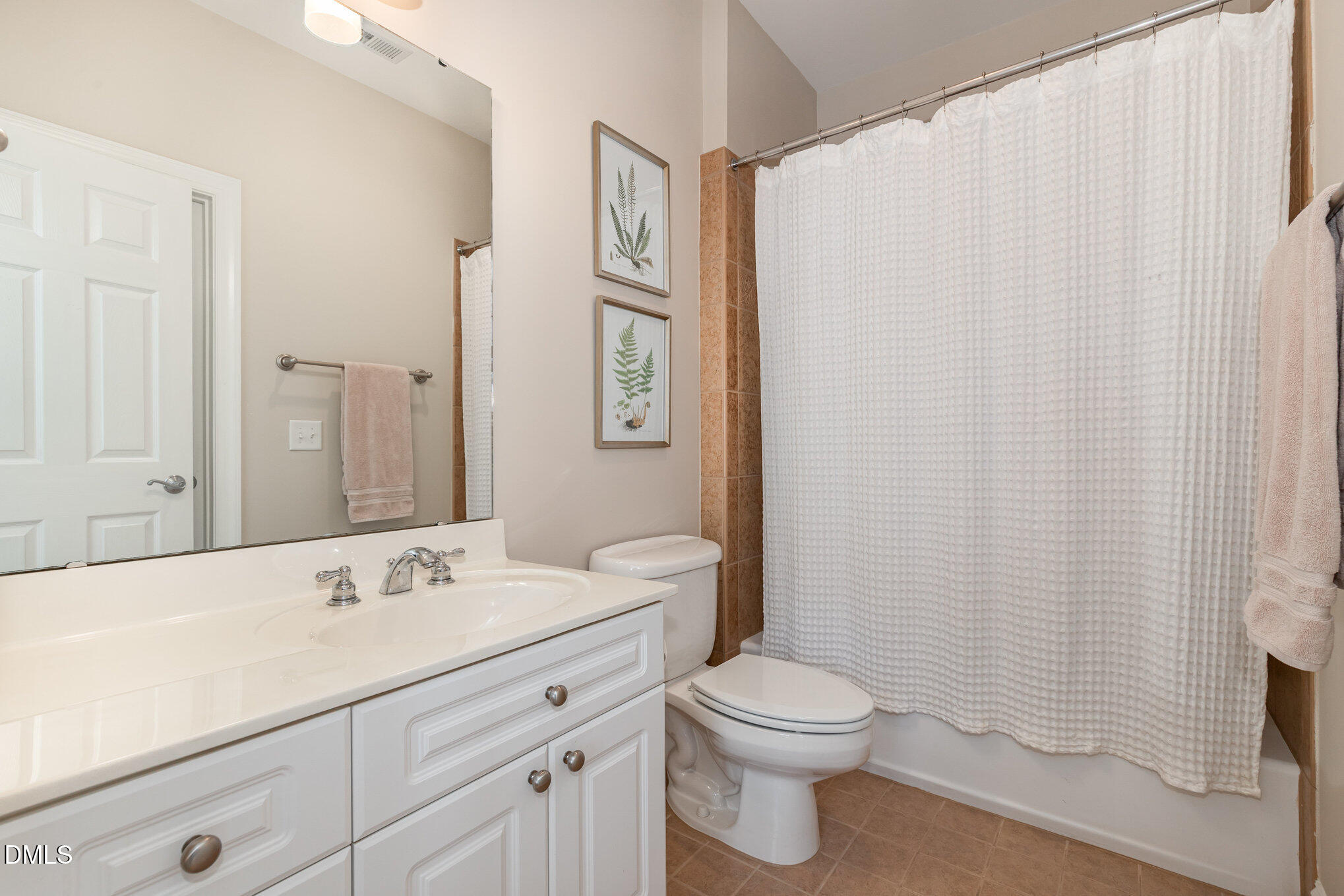 1120 Parkridge Lane, Unit 102 Raleigh, NC 27605 - Photo 32 of 50 a bathroom with a toilet a sink and a mirror
