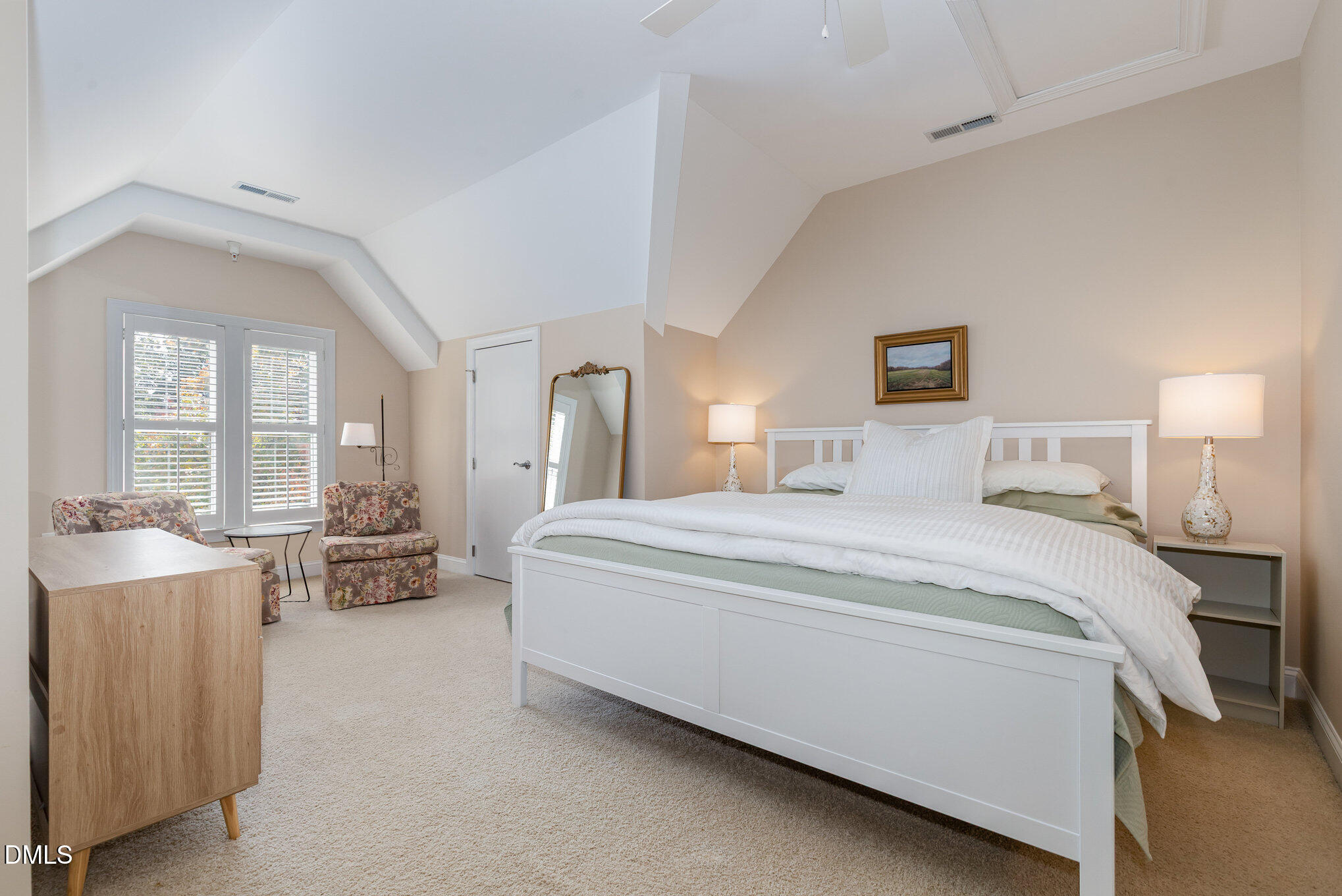 1120 Parkridge Lane, Unit 102 Raleigh, NC 27605 - Photo 34 of 50 a spacious bedroom with a bed a table and chairs