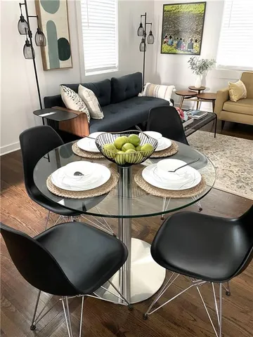 a kitchen with wooden floors and stainless steel appliances