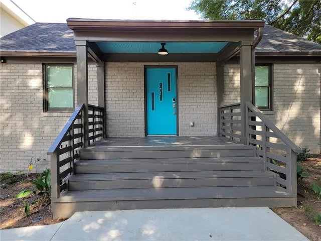 a view of house with wooden deck