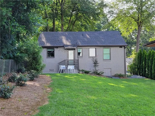 a view of a table and chairs in backyard of the house
