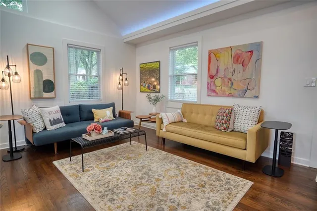 a living room with furniture and wooden floor