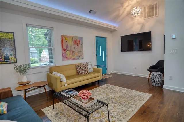 a living room with furniture and a flat screen tv