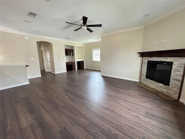 a view of a room with wooden floor and window