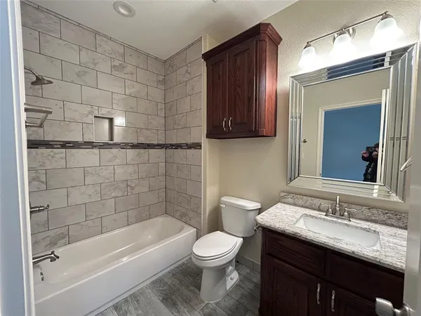 a bathroom with a sink a toilet and bathtub