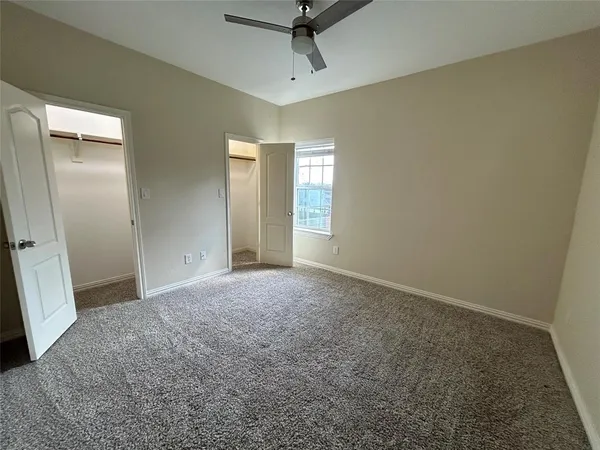 en empty room with closet and fan