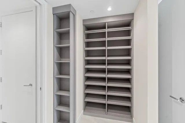 a view of walk in closet with empty racks
