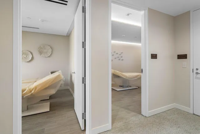 a large white room with a large mirror and sink