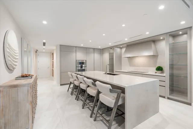 a large kitchen with a table and chairs