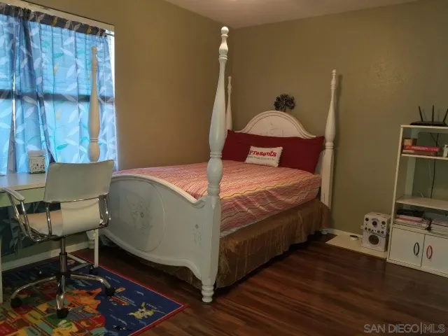 a bedroom with a bed and a tv