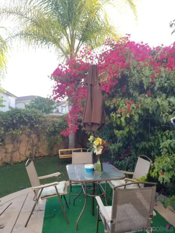 a view of a chairs and table in patio