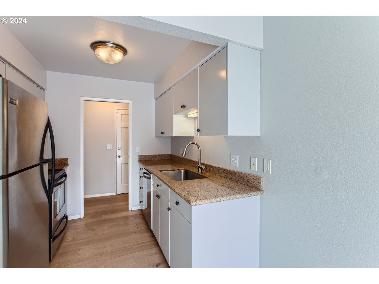 2022 Northeast Clackamas Street Portland, OR 97232 - Photo 6 of 13 a kitchen with granite countertop a sink stove and refrigerator