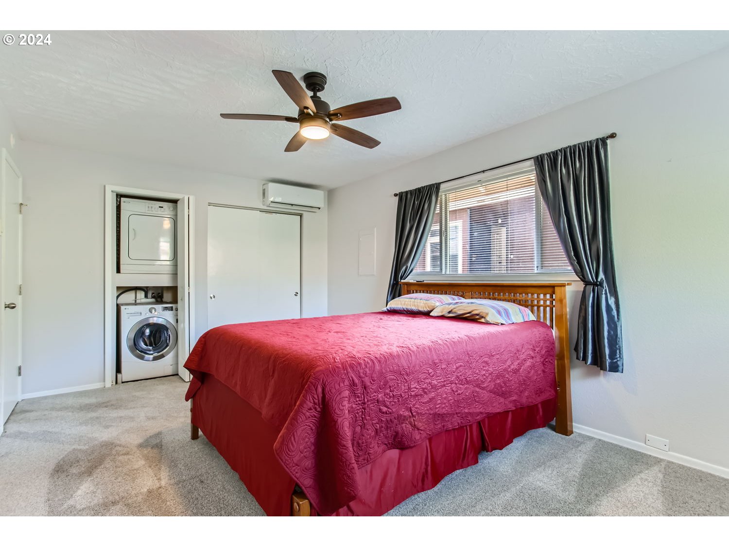 2022 Northeast Clackamas Street Portland, OR 97232 - Photo 9 of 13 a bedroom with a bed and a chandelier