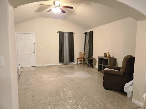 a living room with furniture and a large window