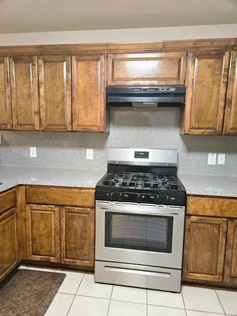 a stove top oven sitting inside of a kitchen