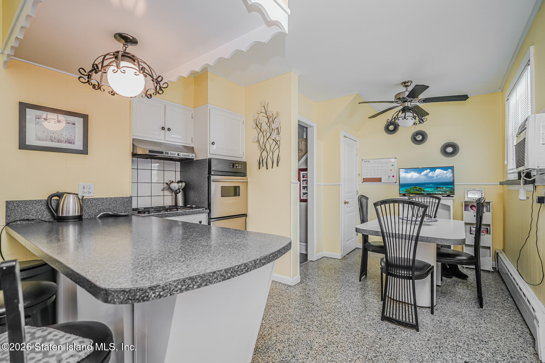 3 3rd Street Staten Island, NY 10306 - Photo 11 of 35 a kitchen with a table chairs and a chandelier