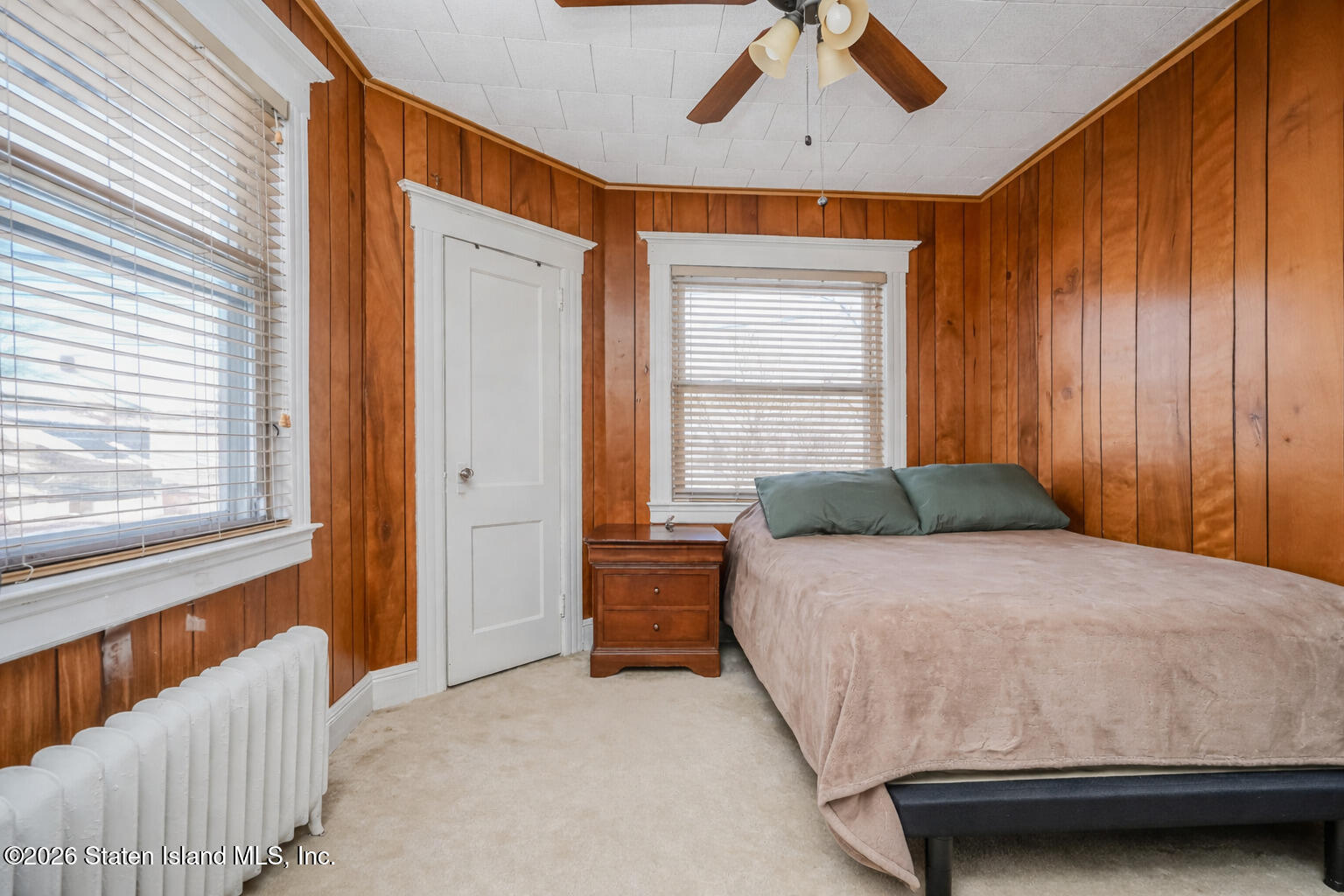 3 3rd Street Staten Island, NY 10306 - Photo 22 of 35 a bedroom with a bed and a chandelier