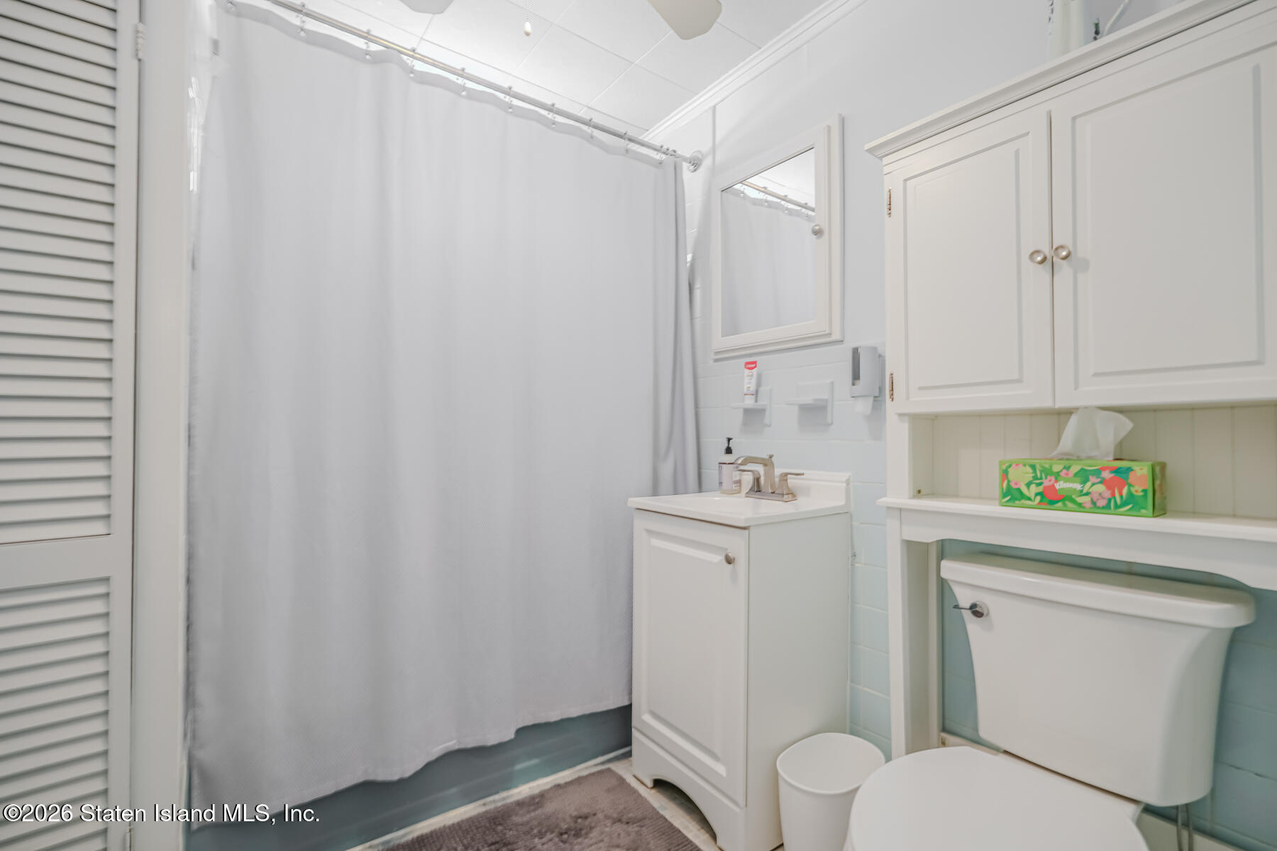 3 3rd Street Staten Island, NY 10306 - Photo 25 of 35 a bathroom with a toilet a sink and a shower curtain