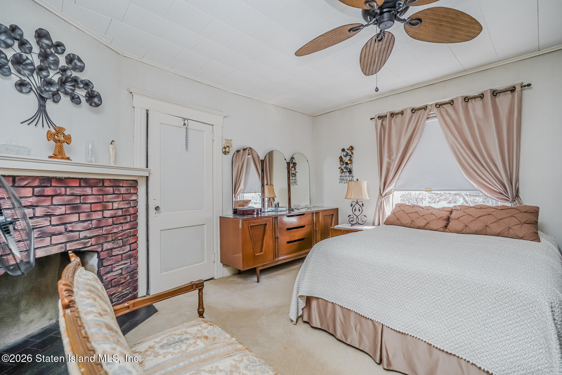 3 3rd Street Staten Island, NY 10306 - Photo 26 of 35 a bedroom with a bed and a chandelier