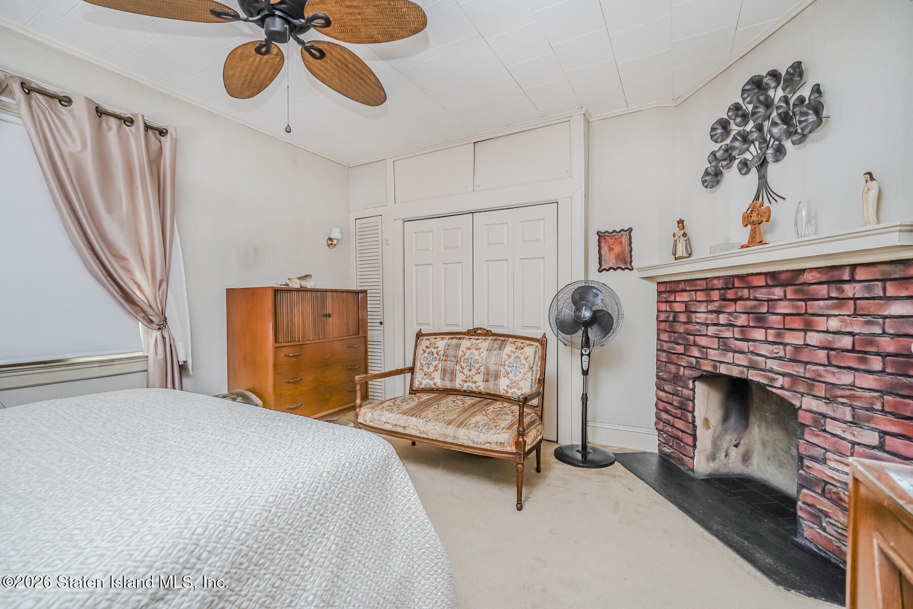 3 3rd Street Staten Island, NY 10306 - Photo 28 of 35 a bedroom with a bed and a chandelier