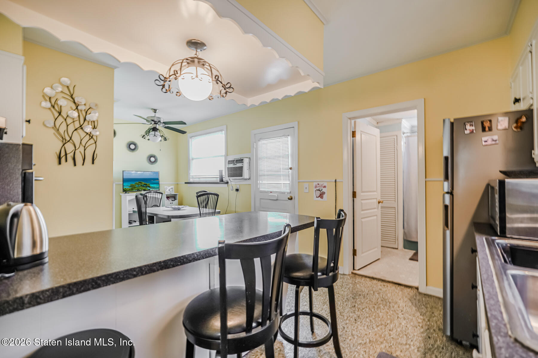 3 3rd Street Staten Island, NY 10306 - Photo 10 of 35 a view of a dining room with furniture a chandelier and wooden floor