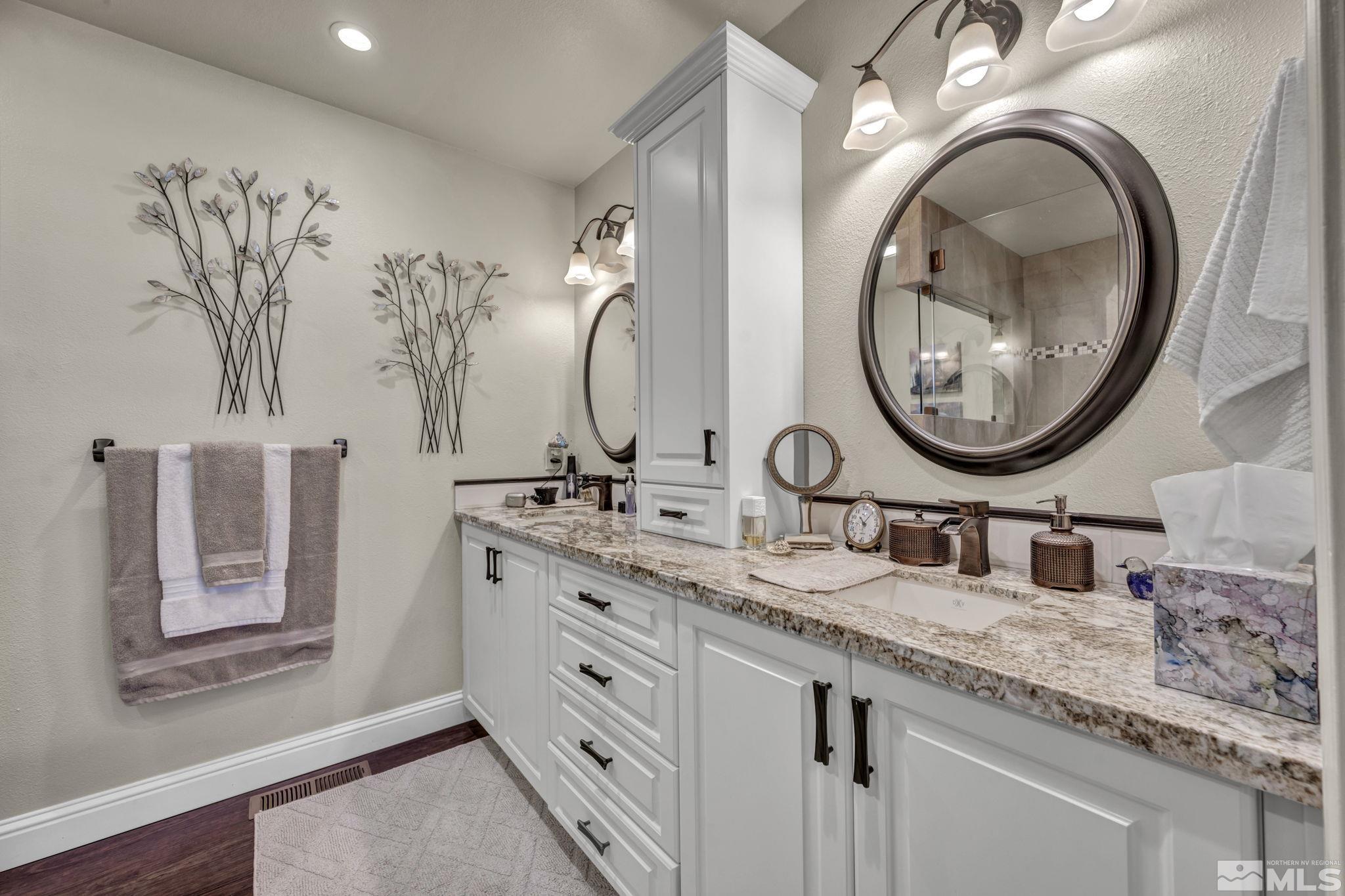 14435 Virginia Foothills Drive Reno, NV 89521 - Photo 20 of 40 a bathroom with a granite countertop double vanity sink and a mirror