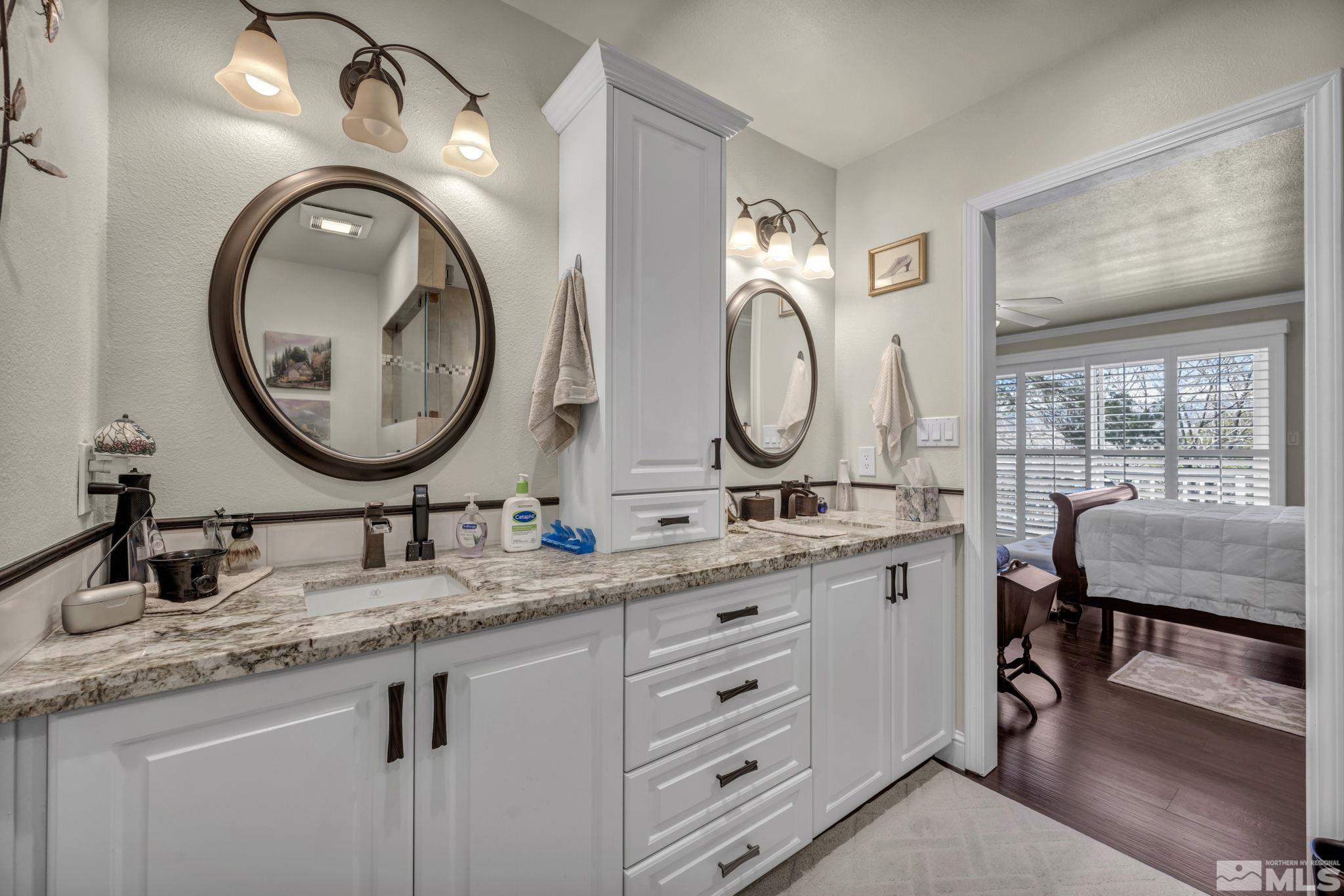 14435 Virginia Foothills Drive Reno, NV 89521 - Photo 21 of 40 a bathroom with 2 sink and a mirror