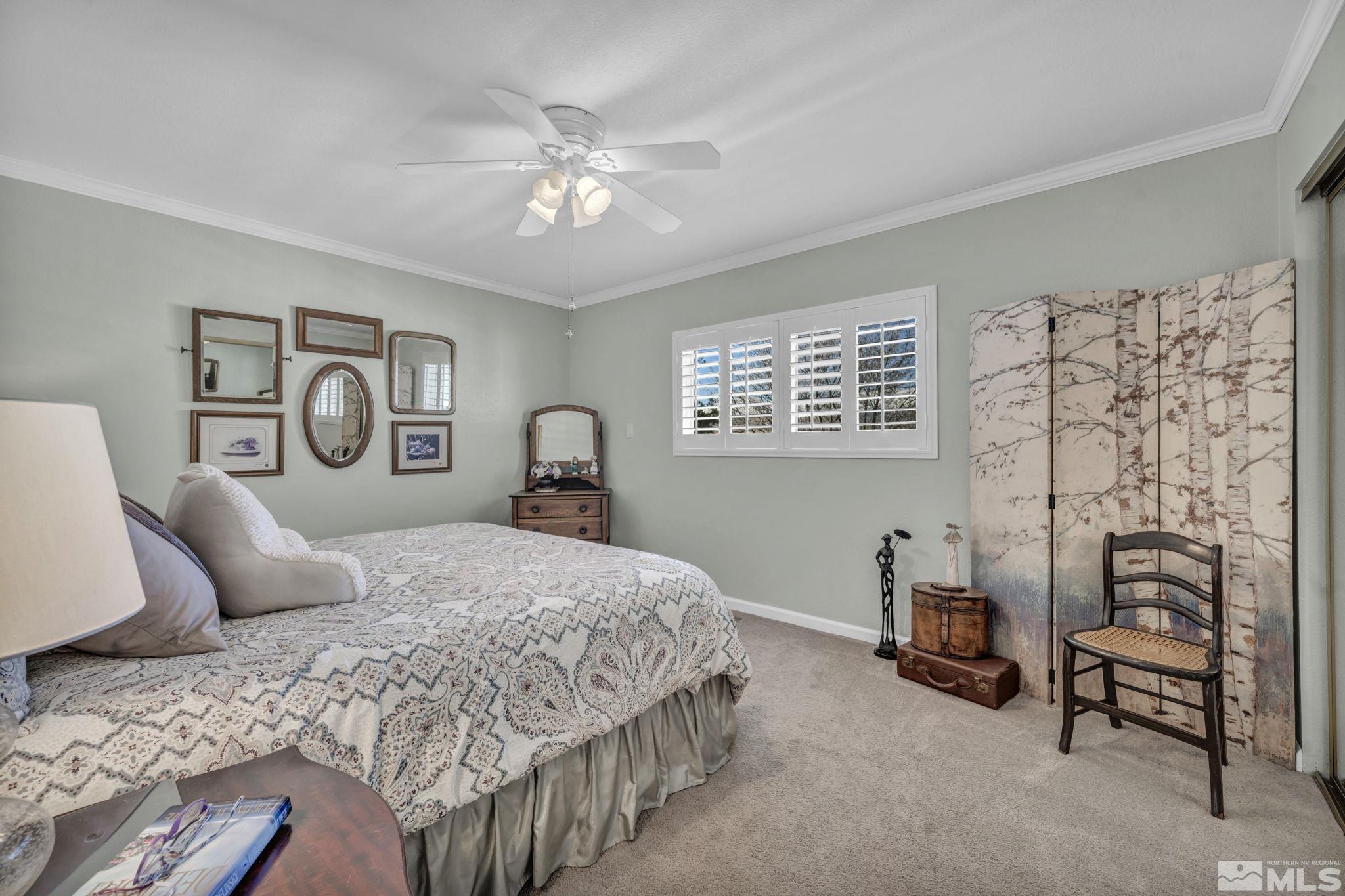 14435 Virginia Foothills Drive Reno, NV 89521 - Photo 23 of 40 a bedroom with a bed and a chandelier