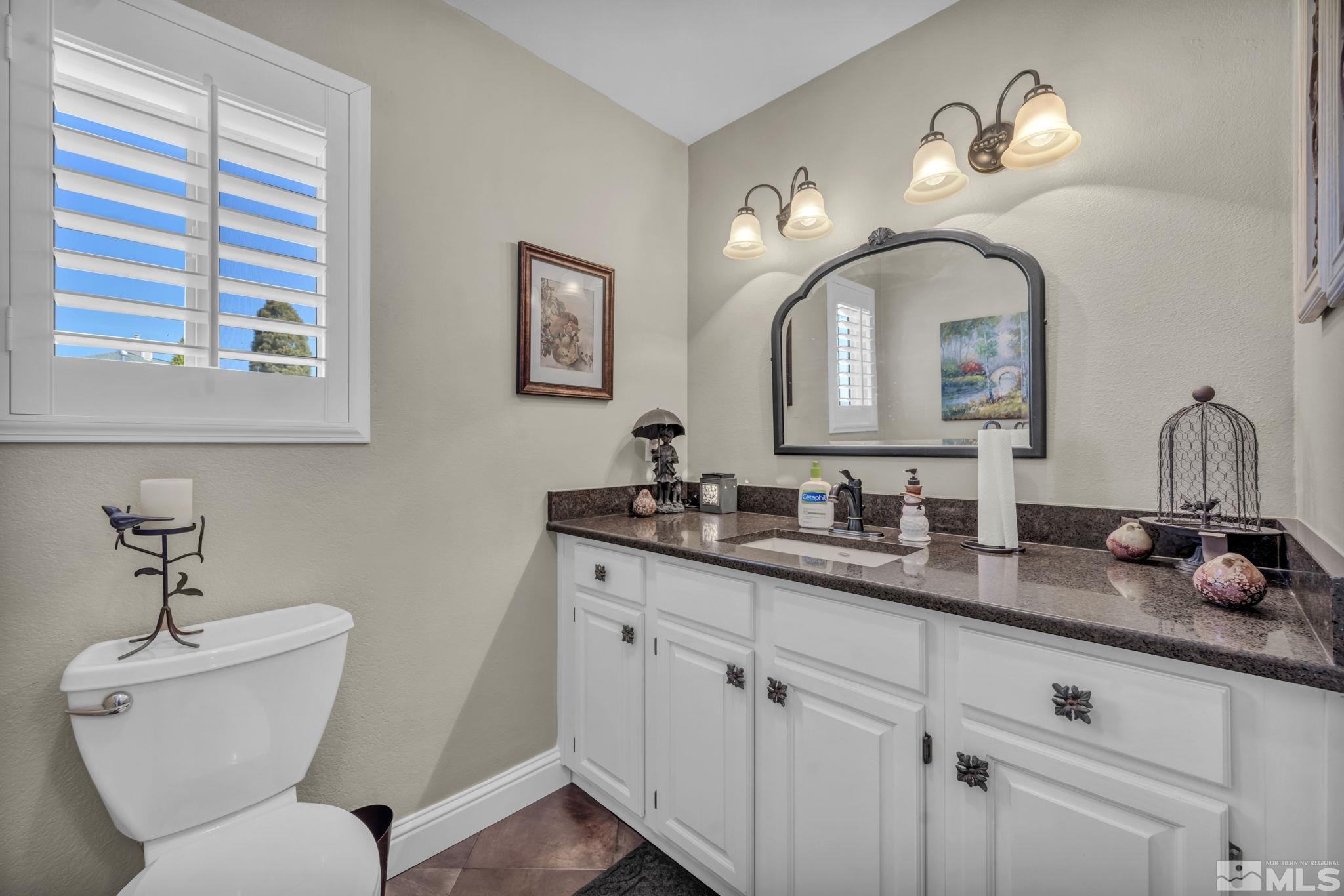 14435 Virginia Foothills Drive Reno, NV 89521 - Photo 27 of 40 a bathroom with a toilet sink and mirror