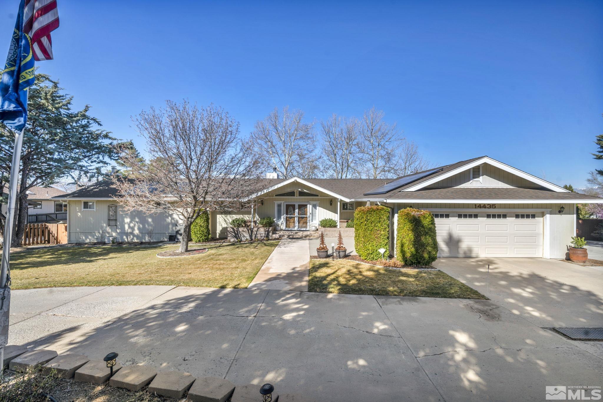 14435 Virginia Foothills Drive Reno, NV 89521 - Photo 3 of 40 a front view of a house with a yard and large trees