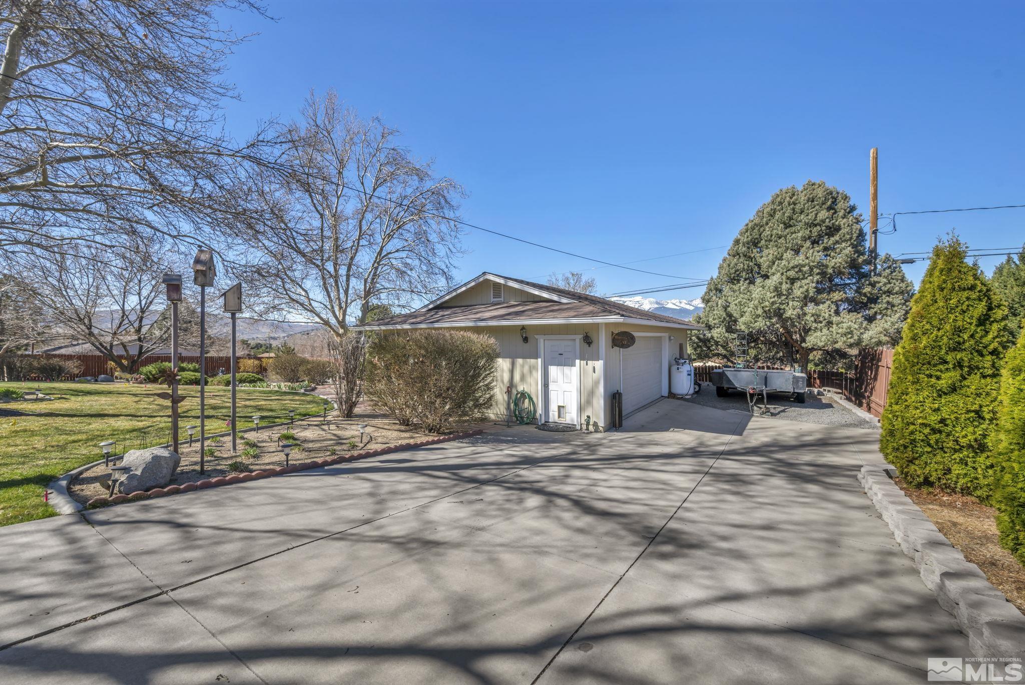 14435 Virginia Foothills Drive Reno, NV 89521 - Photo 32 of 40 a front view of a house with a yard and garage
