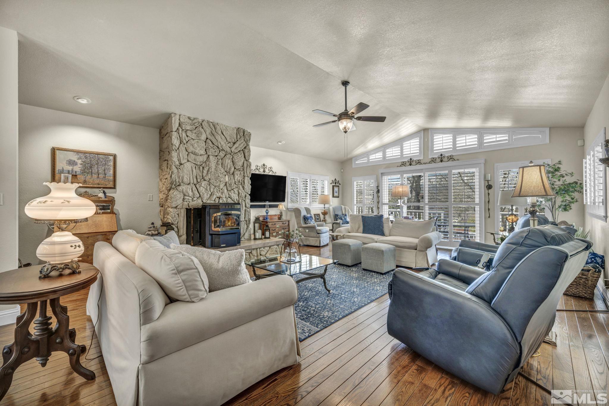 14435 Virginia Foothills Drive Reno, NV 89521 - Photo 9 of 40 a living room with furniture a large window and a fireplace